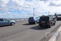 Автотранспорт движется с замедлением скорости из-за срезанного асфальта на полосах дороги